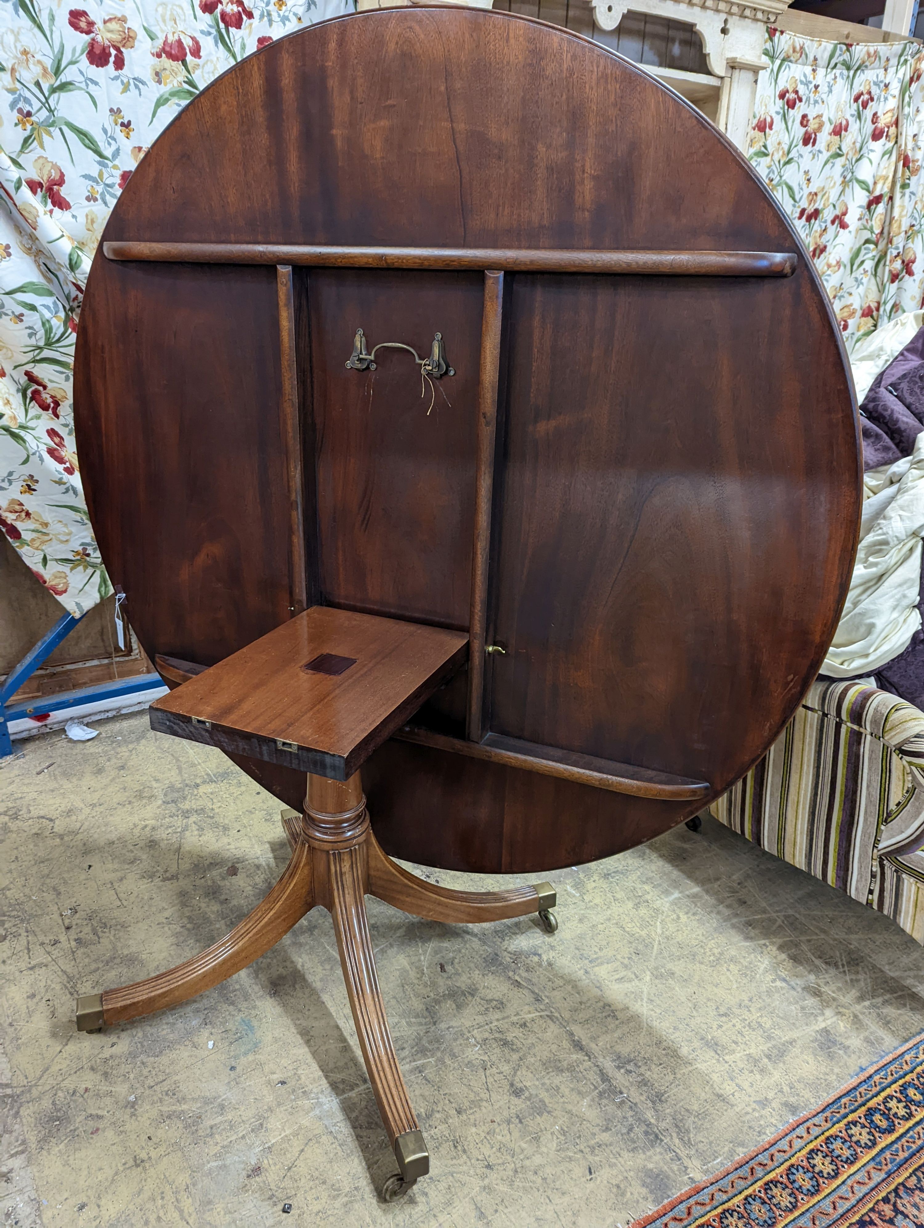 Attributed to William Tillman, a reproduction George III style banded mahogany circular pedestal tilt top dining table, diameter 160cm, height 72cm